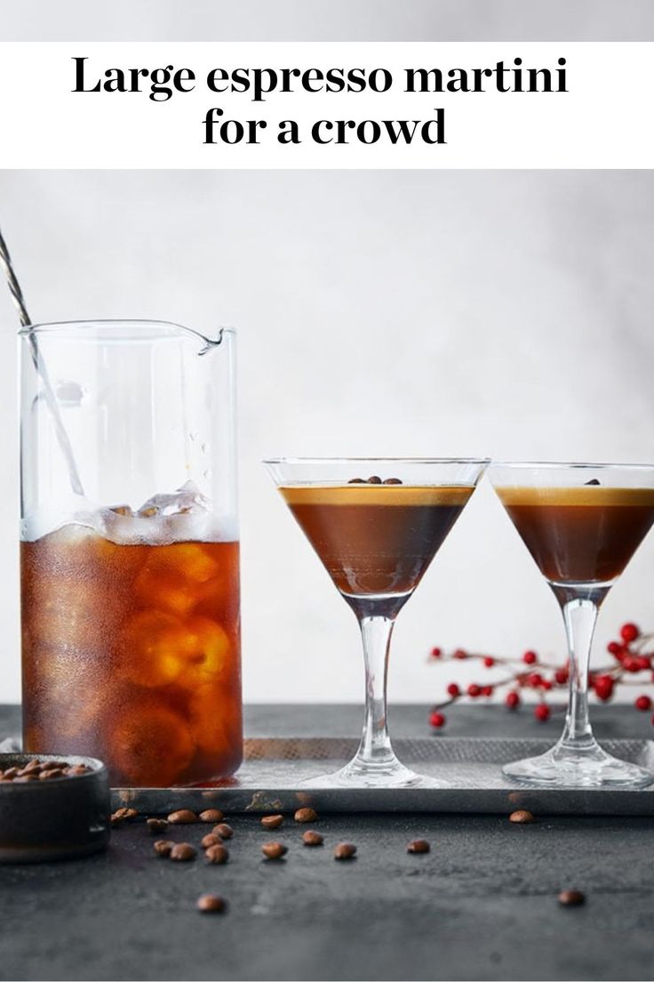 two glasses filled with liquid sitting on top of a table next to another glass full of liquid