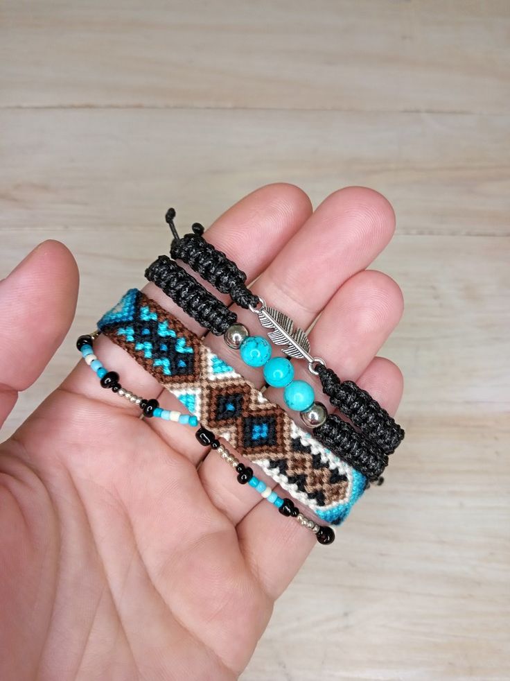 a person holding three bracelets in their hand