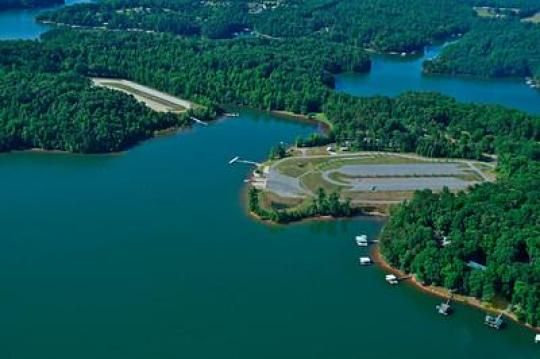 an aerial view of the lake and its surrounding area, with several boats in it