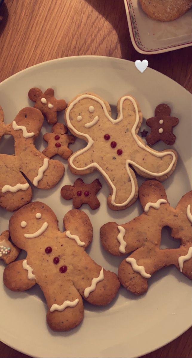 a white plate topped with cut out gingerbread cookies