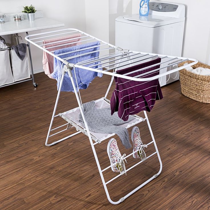 an ironing board with clothes hanging on it