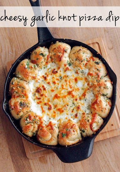 cheesy garlic hot pizza dip in a cast iron skillet on a cutting board