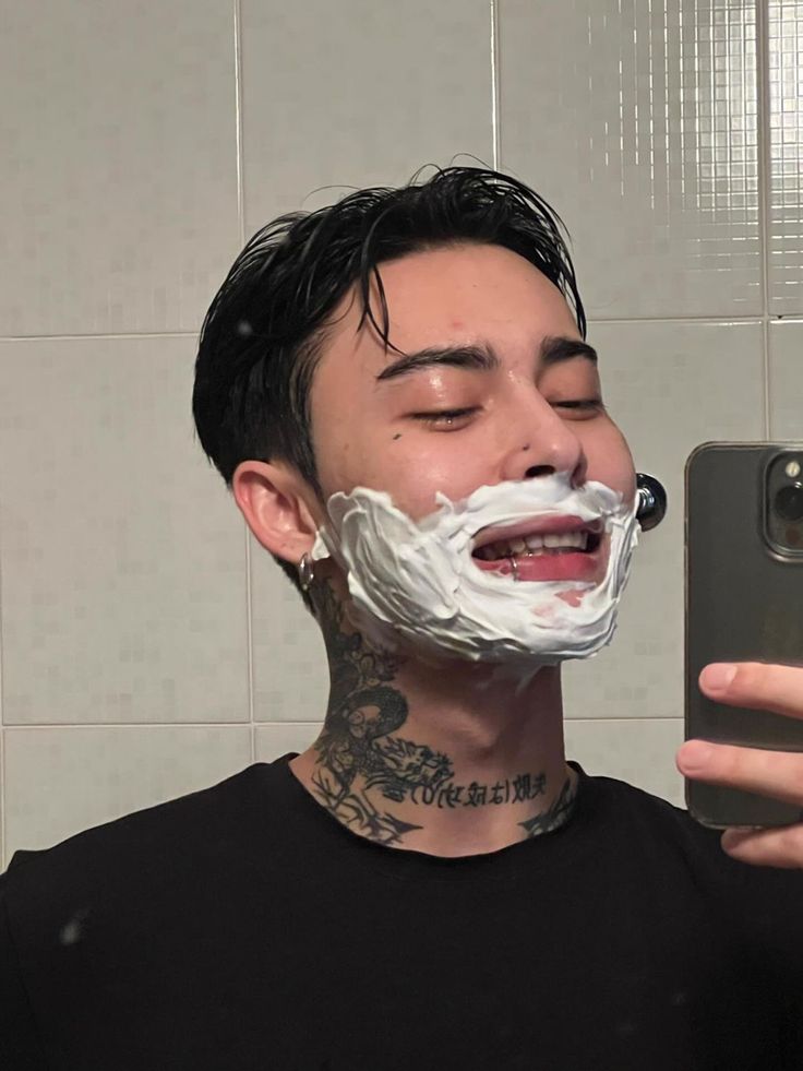 a man is taking a selfie in the mirror with his shaving mask on