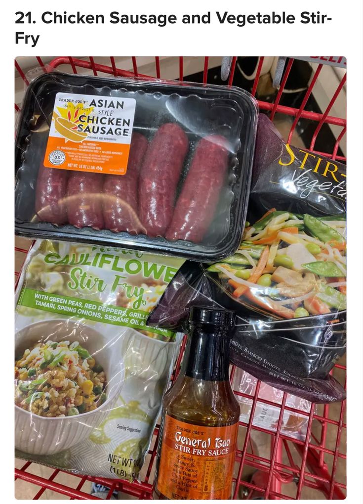 some sausages and vegetables are sitting in a grocery cart with the price label on it