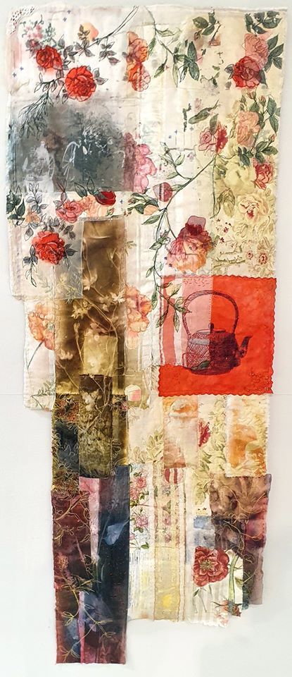 a piece of art that is made out of different types of fabric and paper with flowers on it