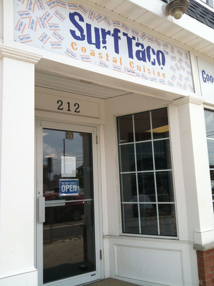 surf taco located on the side of a building with glass doors and large windows