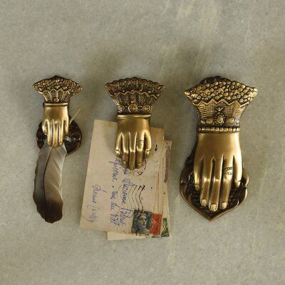 three antique brass hand and feather holders