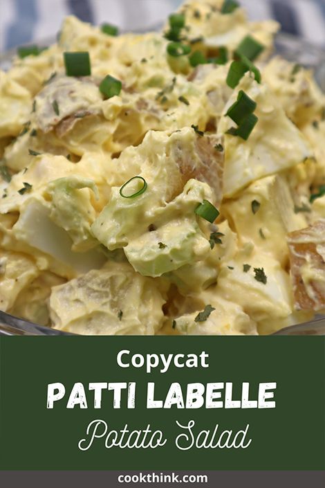 potato salad in a glass bowl with green onions