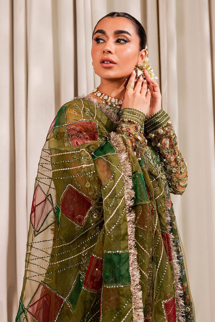 Mehndi Green Multicolored Pakistani Kameez Sharara Wedding Dress is a traditional attire adorned with gota, dabka, and naqshi work. Lavish designs and fine embroidery make this Pakistani Sharara Dress an epitome of beauty and grace. Embroidered Kameez: The kameez comes has a beautiful brown color. Hand-crafted details of dabka, motifs, and naqshi give a glamorous look to this green kameez. Traditional gota and lavish designs make this kameez a perfect choice to wear on the wedding. Sharara Kamee Elegant Pakistani Wedding Dress, Sharara Wedding, Green Kameez, Green Gharara, Pakistani Kameez, Wedding Core, Garara Dress, Net Frock, Mehendi Dress