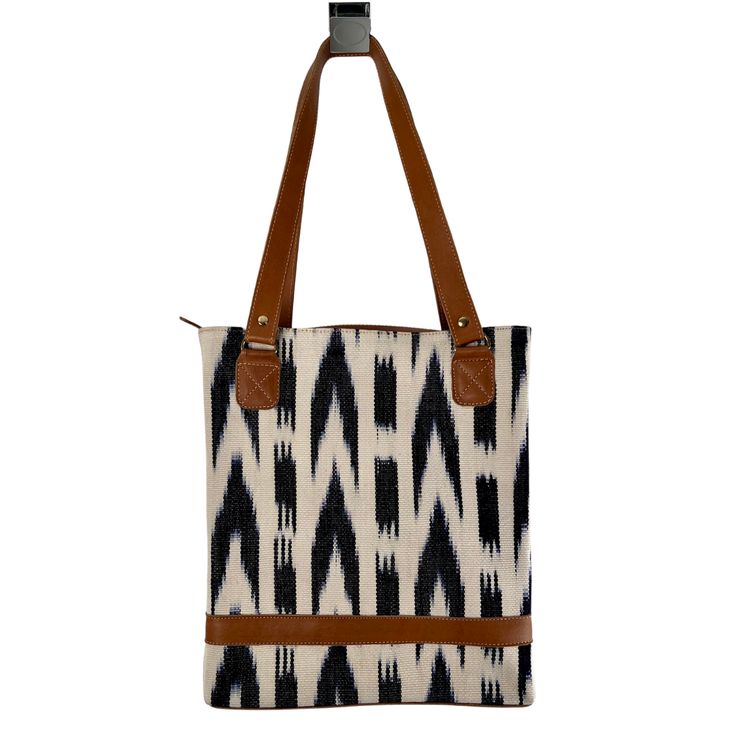 Looking for a uniquely gorgeous structured bag? Look no further! The jaspe (ikat) structured tote is made of handspun and handwoven fabric designed by the women of Ruk’U’X Keem of San Juan La Laguna, Guatemala. Cuero Malec, a Guatemalan leather shop, transforms the fabric into gorgeous, durable bags. Artisan Shoulder Bag With Weaving Work, Artisan Shoulder Bag With Weaving Work For Everyday, Artisan Bags With Weaving Work For Everyday Use, Brown Shoulder Bag With Weaving Work For Daily Use, Artisan Bags With Weaving Work, Daily Use Tote Shoulder Bag With Weaving Work, Daily Use Weaving Work Bags, Structured Bag, Handwoven Fabric