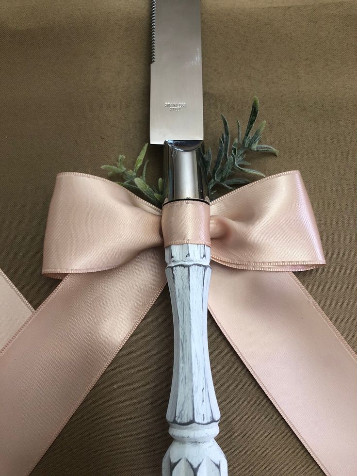 a knife with a bow tied around it