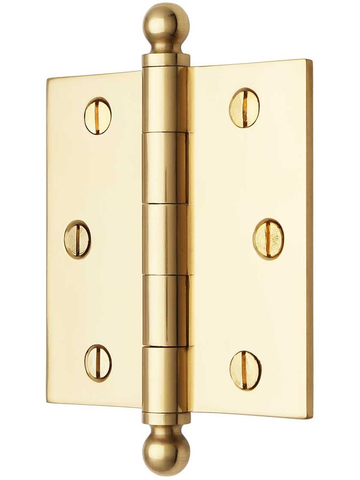 a brass plated door hinge with three knobs