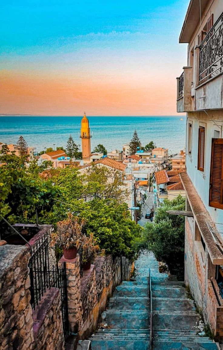 stairs lead down to the beach with buildings in the background