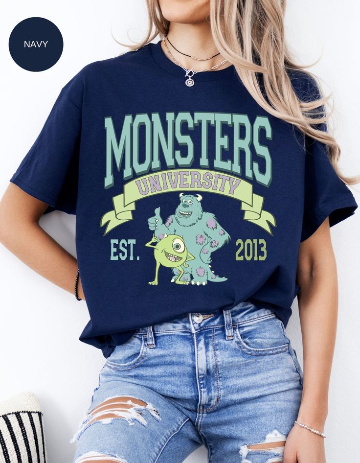 a woman with her hands on her hips wearing a monster t - shirt that reads monsters university est 2013