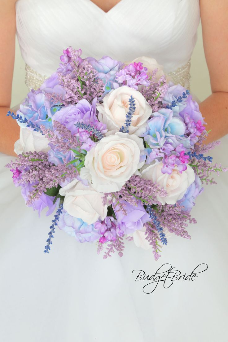 a bride holding a purple and white bouquet