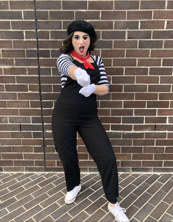 a woman dressed in black and white poses for the camera