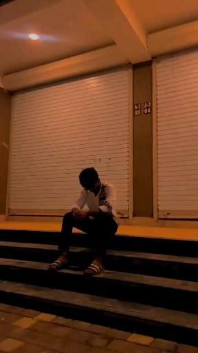 a man sitting on the steps in front of closed doors