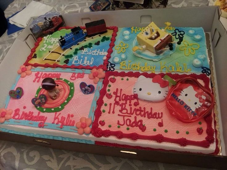 a birthday cake in a box with hello kitty decorations on the top and other items around it