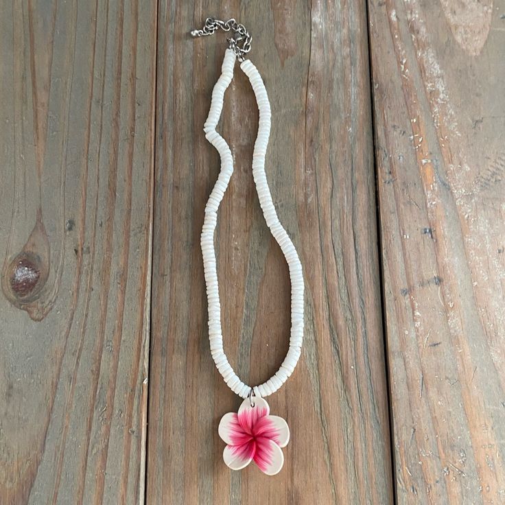 White Pooka Shell With White And Pink Plumeria On This Nwot Necklace White Flower Jewelry For Vacation, White Adjustable Flower Pendant Necklace, White Flower Pendant Jewelry For Beach, White Adjustable Flower Necklace, Handmade White Flower Necklace, White Beaded Flower Pendant Jewelry, White Beaded Flower Pendant Necklace, White Beaded Flower Necklace, White Flower-shaped Beaded Necklaces For Gifts