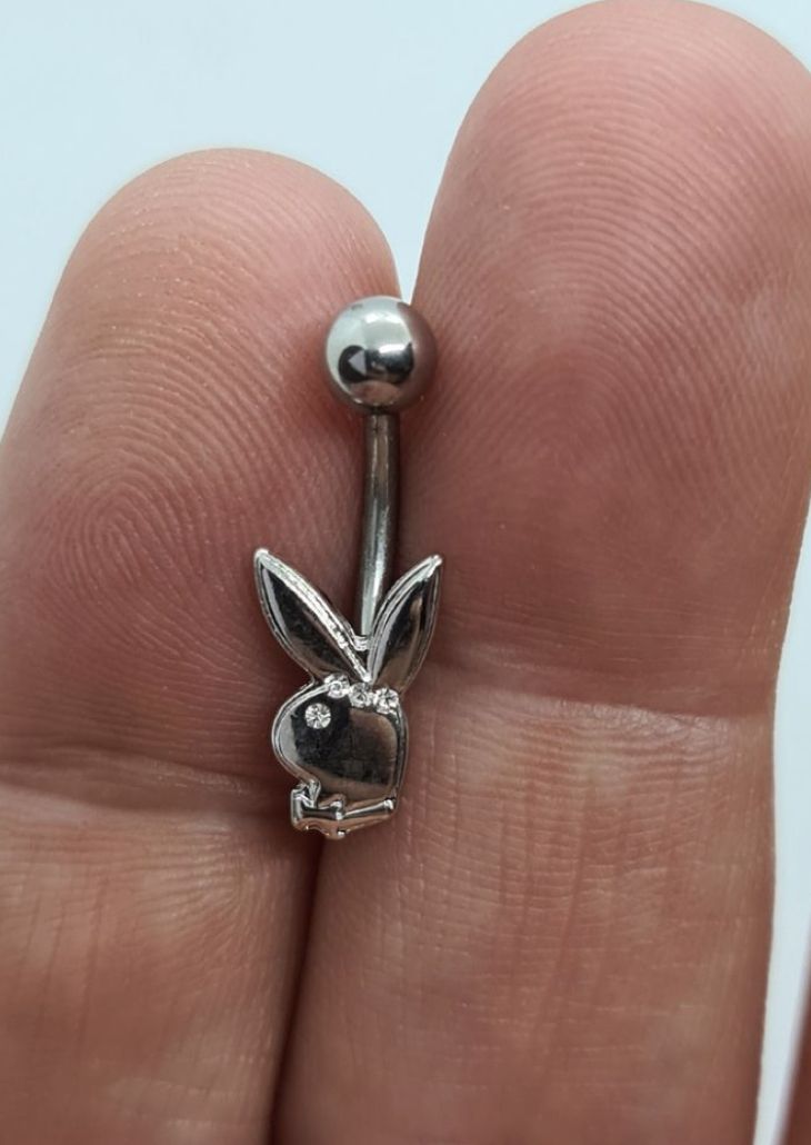 a person is holding a tiny nose ring