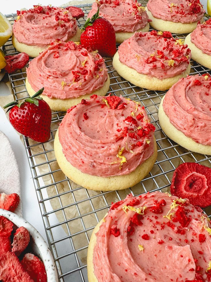 strawberry shortbreads with frosting and strawberries on a cooling rack, ready to be eaten