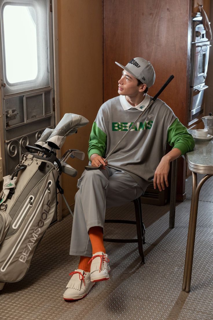 a man sitting in a chair next to a golf bag