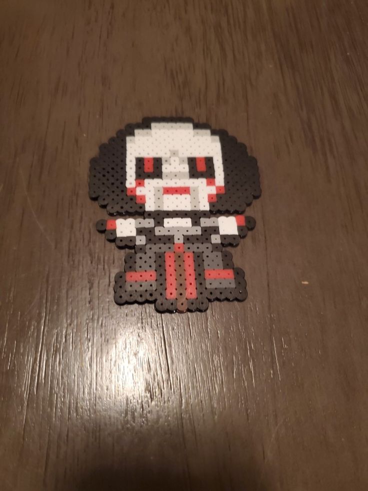 an image of a sticker that looks like it is in pixel art style on a wooden surface