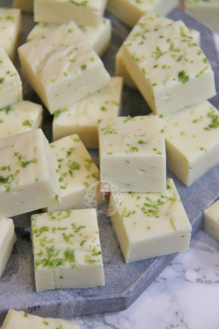 several pieces of cheese sitting on top of a marble counter with green sprinkles