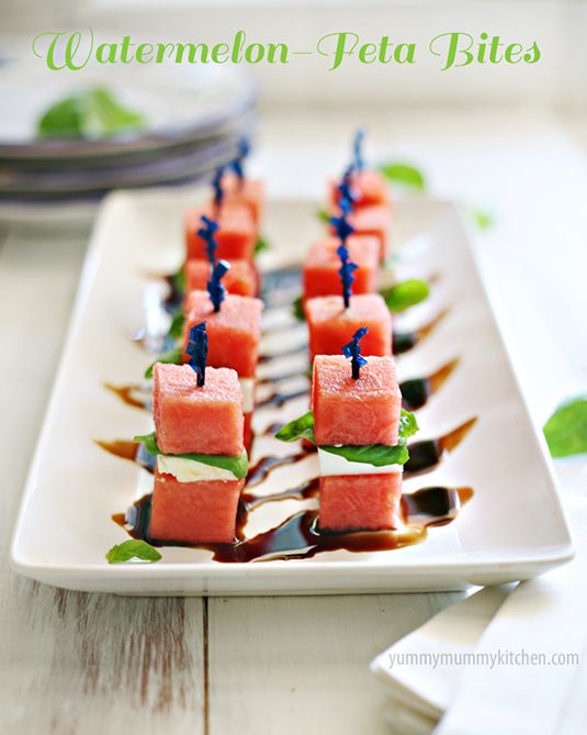 watermelon skewers are arranged on a white plate