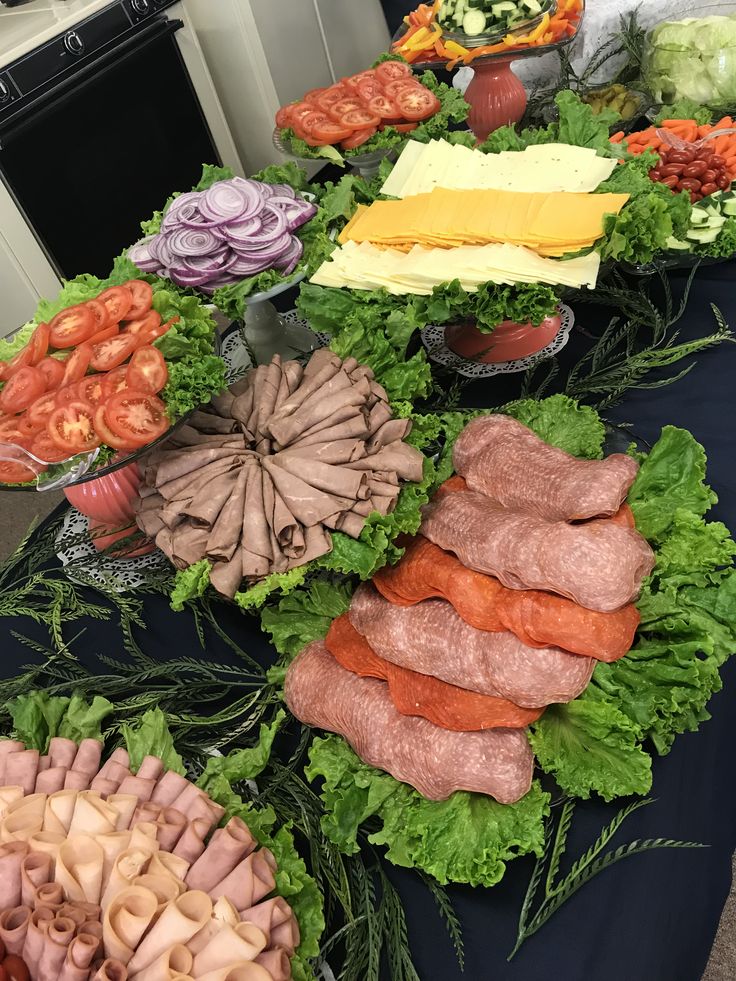 an assortment of meats and vegetables on a table