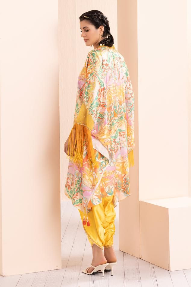 Yellow leafy ash tunic with abstract print and thread and mirror embroidered neckline. Comes with dhoti pant.
Components: 2
Pattern: Printed, Embroidered
Type Of Work: Abstract, Thread, Mirror
Neckline: V Neck
Sleeve Type: Flared Sleeves
Fabric: Satin, Organza
Color: Yellow
Other Details: 
Tasseled detailing on kurta
Occasion: Sangeet - Aza Fashions V Neck Tunic, Dhoti Pants, Yellow Satin, Embroidered Neckline, Print Tunic, Pant Set, Set For Women, Flared Sleeves, Aza Fashion