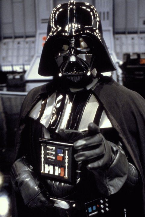 darth vader is holding a small electronic device