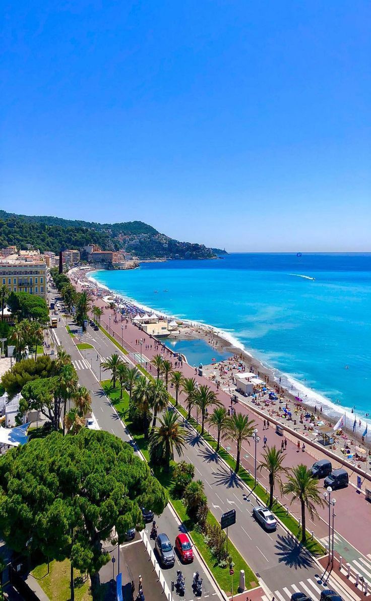 an aerial view of the beach and ocean from a high rise building in nice weather