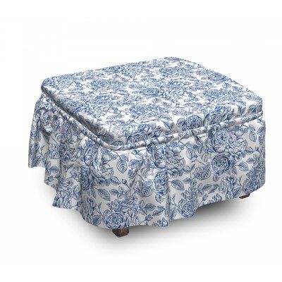 a blue and white ottoman with a flowered design on the top, sitting in front of a white background