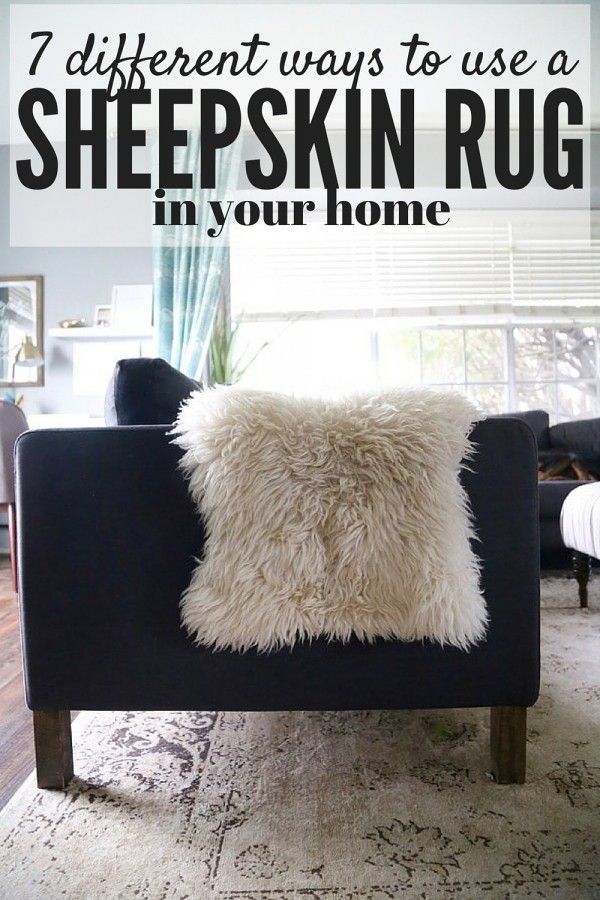 a black couch with a white pillow on it in front of a window that says, different ways to use a sheepskin rug in your home