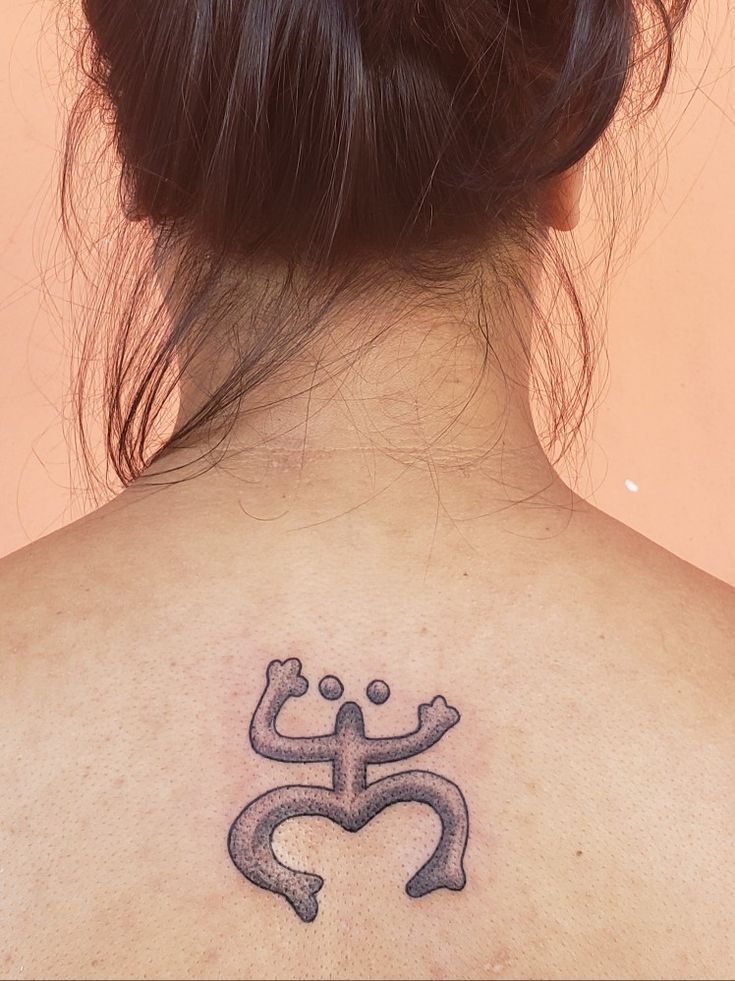 a woman with a tattoo on her back