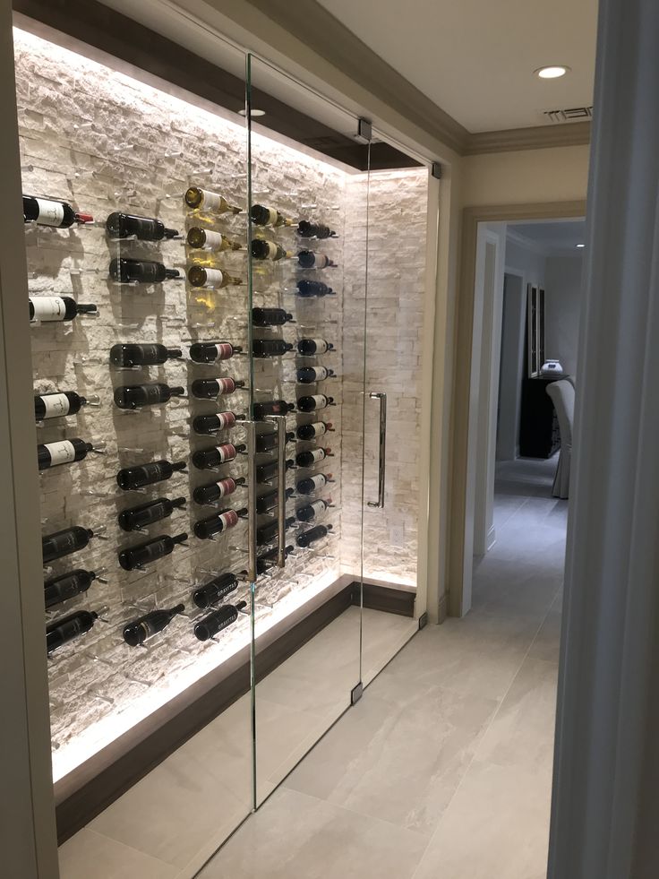 a wine cellar with many bottles of wine on the wall and in between two walls