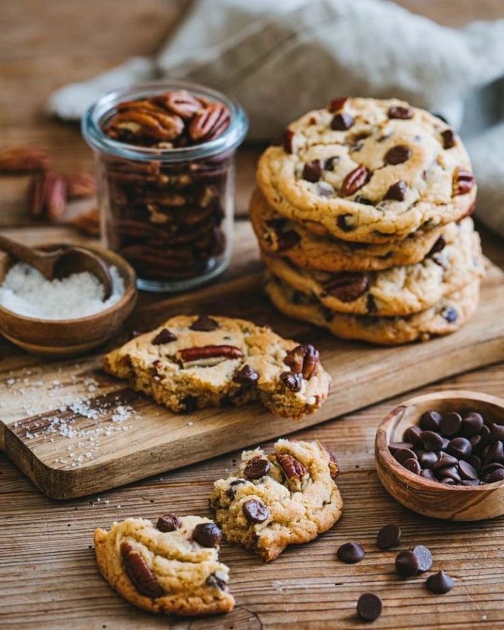 chocolate chip cookies and pecans on a cutting board