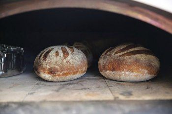 two loaves of bread sitting in an oven