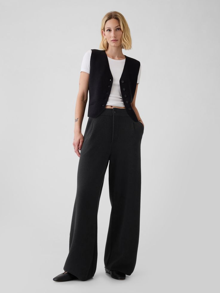 Supersoft cotton-blend sweater trousers.  Button closure, zip fly.  Front slant pockets.  Pleating at front.  This trouser is made with 25% recycled polyester.  Compared to virgin materials, using recycled materials helps to reduce resource use and waste.  Fit: Relaxed.  An easy silhouette throughout.  Models wearing Gap Black Trouser Office Outfit, Avant Garde Office Wear, Hip Hop Business Casual, Punk Business Attire, Smart Business Casual Women Work Clothes, Nonbinary Office Fashion, Formal Trousers Outfit, Relaxed Teacher Outfit, Minimalist Goth Outfit