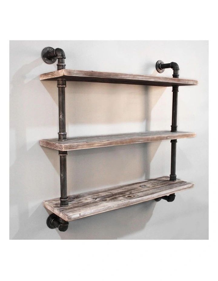 an industrial style shelf with two pipes and wheels on the bottom, against a white wall