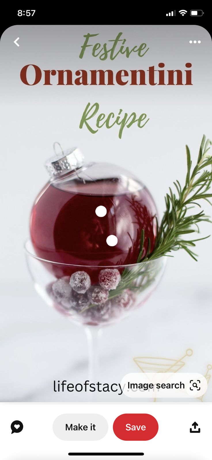 a wine glass filled with red liquid on top of a table