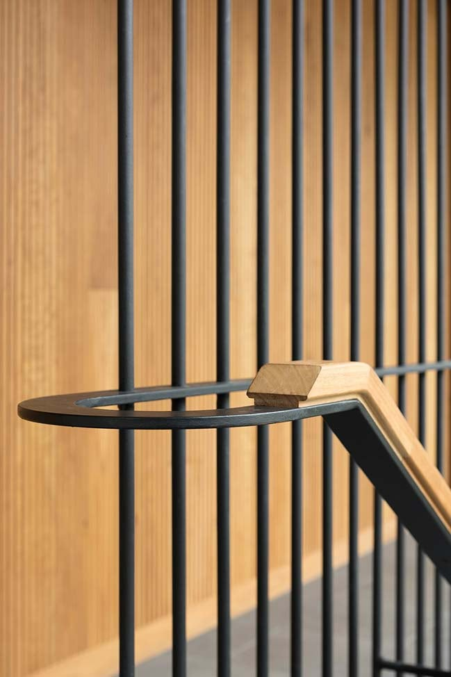 a close up of a metal fence with wooden bars on the top and bottom part