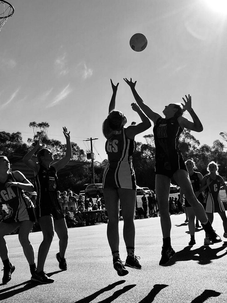 some girls are playing basketball on the court