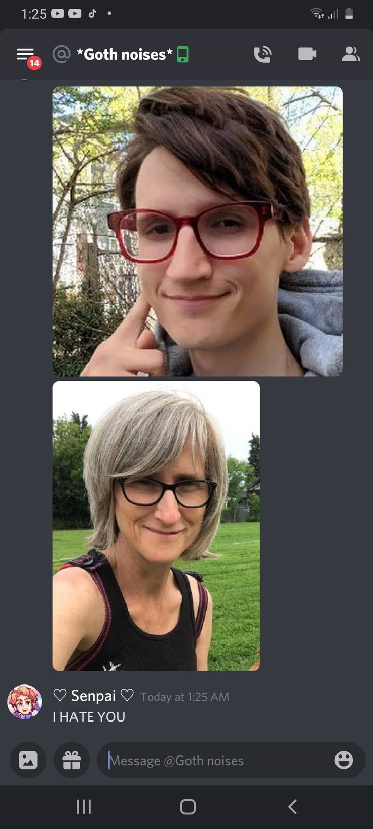 two people with glasses are smiling and looking at the same person's phone screen