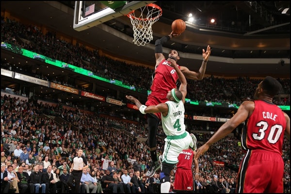 the basketball player is jumping up to dunk the ball