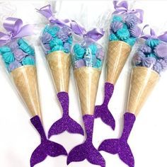 three cones with purple and blue flowers in them on a white background, one cone is shaped like an ice cream cone