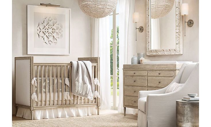 a baby's room with a crib, dresser and mirror