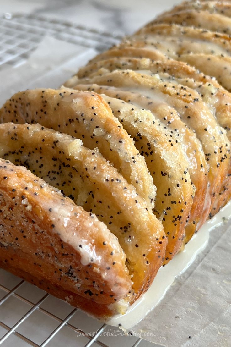 a loaf of poppy seed bread on a cooling rack