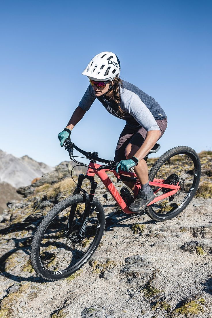 a man riding a bike down a rocky slope